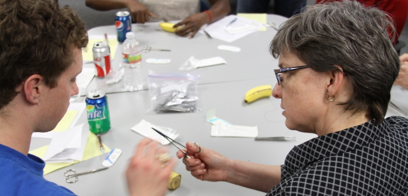 Faculty member Juliet McKee, MD teaching a student during a hand-on workshop